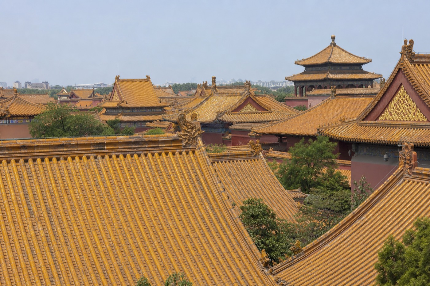 A wide view over the Forbidden City's golden rooftops toward the central axis