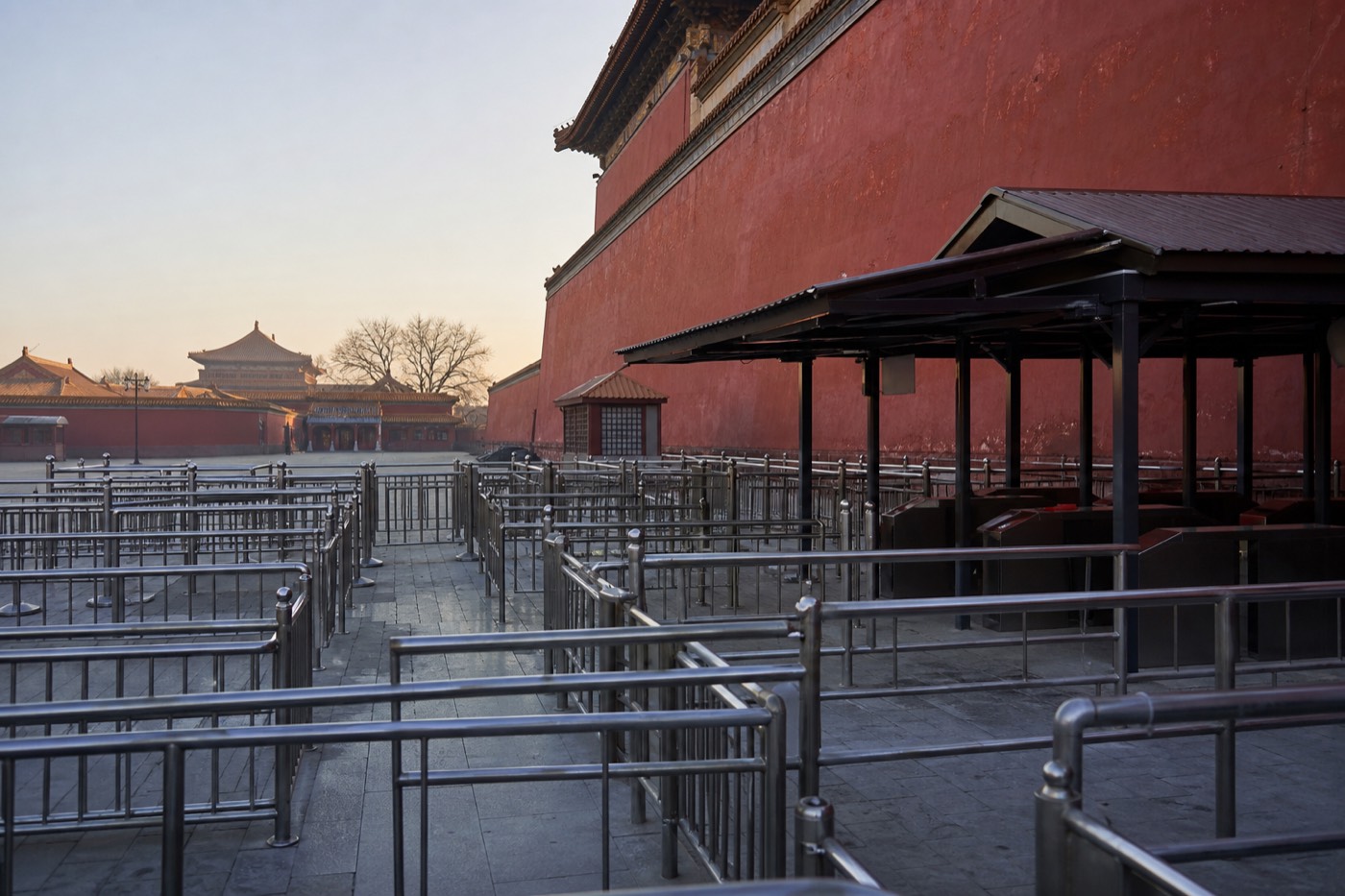 Visitors waiting with passports ready at a Forbidden City entrance checkpoint in the morning